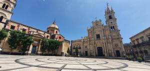 a cathedral with a labyrinth in the middle of a courtyard at Antica Dimora Barocca in Acireale