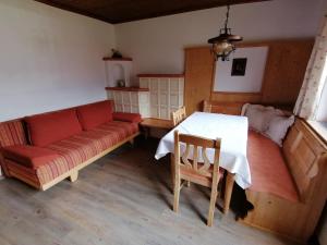 a living room with a couch and a table at Haus Zangerl in Walchsee