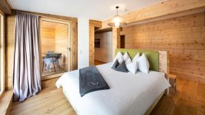 Łóżko lub łóżka w pokoju w obiekcie ALMGUT - Mountain Wellness Hotel