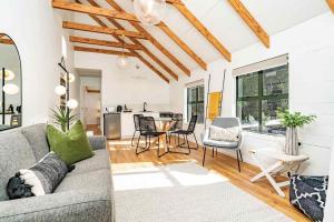 a living room with a couch and a table at Tui & Nikau Cabins in Mangawhai