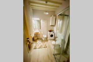 a small bathroom with a toilet and a sink at Sisters’home in Cortona +148 photos