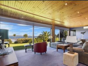 a living room with a view of the ocean at The Lodge in Low Head