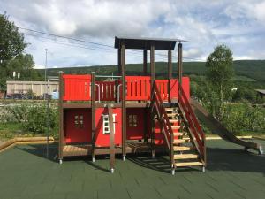 a playground with red play equipment on a roof at Øen Turistsenter Cottages in Geilo
