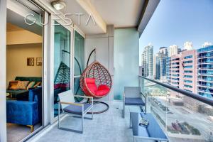 a balcony with a couch and a swing at The Waves by DAMAC, Dubai Marina in Dubai