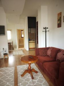 a living room with a red couch and a table at Apartman Milica in Kremna