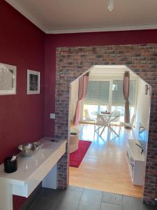 a kitchen and living room with a brick wall at Appartemment 2 EuroAirport Basel-Mulhouse-Freiburg in Saint-Louis
