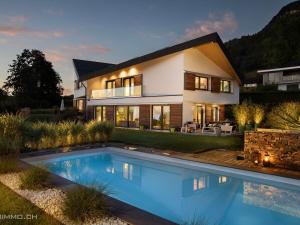 a house with a swimming pool in front of it at Montreux Holiday Home in Montreux