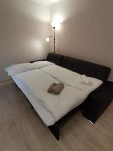 a large bed with two slippers on top of it at Apartma VRTNICA in Bovec