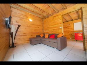 a living room with a couch in a wooden room at Chalet rodali in Saint-Pierre