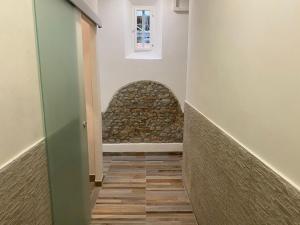 a hallway with a stone wall and a stairway at My Friends in Florence