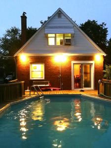 a house with a swimming pool in front of a house at Comfort Home Toronto in Toronto