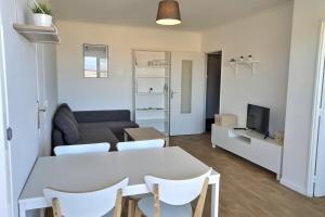 a living room with a table and a couch at Lala Springs Anglet - Vue océan - WIFI - Balcon in Anglet