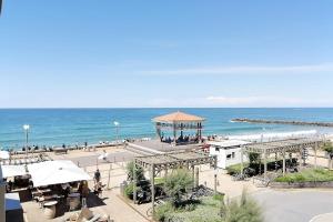 a view of a beach with a gazebo and the ocean at Lala Springs Anglet - Vue océan - WIFI - Balcon in Anglet
