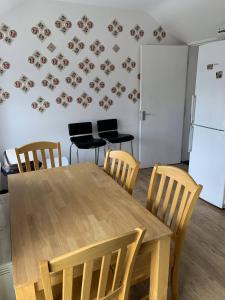 a kitchen with a table and chairs and a refrigerator at Stylish Dublin Apartments in Dublin