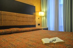 Posteľ alebo postele v izbe v ubytovaní Hotel Enrichetta