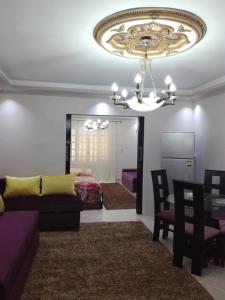 a living room with a couch and a chandelier at Borg Barka - Families Only in Alexandria