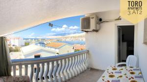 a balcony with a view of the ocean at Apartments Toro in Pag
