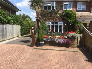 a house with a bunch of flowers in front of it at Albertine ,A warm welcome awaits you ,Offering en-suite room only accommodation,Ideal location for Solent Way ,High Street ,Isle of Wight ,New Forest in Lymington +27 photos