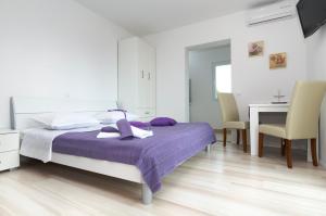 a bedroom with a bed and a table and chairs at SEA VIEW sTUDIO MARIJETA in Tučepi