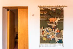 a tapestry hanging on a wall in a room at Hotel Ayook in Oaxaca City
