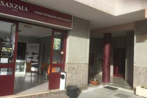 an entrance to a building with a red door at Charming Family Large Apartment in Bragança