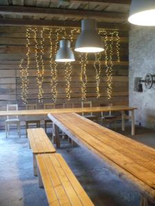 a row of wooden benches in a room with lights at Chalupa Na Bidýlku in Jindřichŭv Hradec