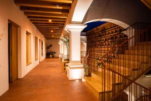 a hallway of a building with a staircase and columns at Hotel Ayook in Oaxaca City