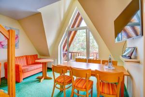 a room with a table and chairs and a couch at HAFFHUS - Hotel & Spa in Ueckermünde