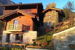 a large wooden house with a balcony on top of it at Villetta Piemartin in Saint Vincent