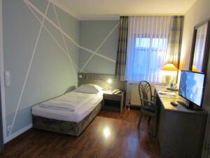 Postel nebo postele na pokoji v ubytování Art-Hotel Erlangen