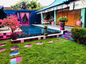 a house with a swimming pool in the yard at Villa Majorelle Bali in Seminyak