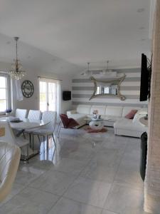 a living room with a white couch and a table at Apartments Brač in Supetar