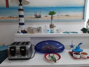 a kitchen counter with a toaster and a plate of food at Bed By Boat @Nonthaburi Pier in Nonthaburi