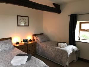 
a bedroom with a bed and a desk at The Garsdale Bed & Breakfast - Goats and Oats at Garsdale in Hawes
