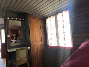 a bedroom with a mirror and a bed and a window at La roulotte de Bussy in Bussières +7 photos