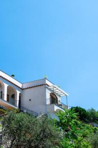 
a large white building with a blue roof at Villa genny and emily in Positano
