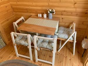 una mesa de madera y sillas en una habitación en Glamping Huts in Heart of Snowdonia en Dolgellau