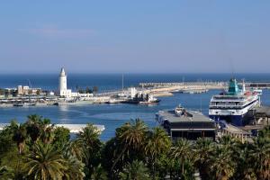 a harbor with boats and a lighthouse in the water at El Encanto in Fuengirola