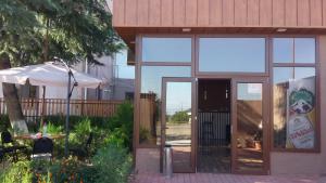 a building with a glass door and an umbrella at комфорт in Marneuli