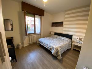 a bedroom with a bed and a window at Appartamenti Altea in Sirmione