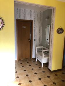 een kamer met een deur, een spiegel en een vloer bij Haus Zissi in Burg-Reuland