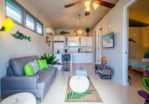 a living room with a couch and a kitchen at Villas at Aguada Sea Beach in Aguada