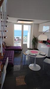 a living room with a couch and a table at Apartmani Antonieta in Veli Lošinj