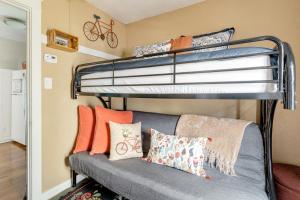 a room with two bunk beds and a couch with pillows at Casita Charm, Cozy Character in Long Beach