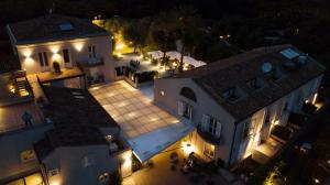 an aerial view of a building at night at Donna Carmela Resort & Lodges in Riposto