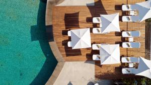 an overhead view of chairs and umbrellas next to a pool at Donna Carmela Resort & Lodges in Riposto