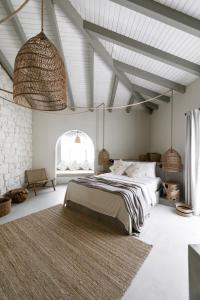 a bedroom with a large bed and a large window at GAIA Alaçatı Bazaar in Alacati