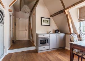 a kitchen with a stove and a table in a room at Abbey Abcoude in Abcoude