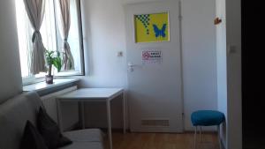 a room with a door and a table and a window at Art Hostel in Krakow