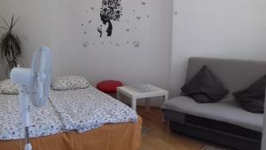 a small bedroom with a bed and a couch at Art Hostel in Krakow